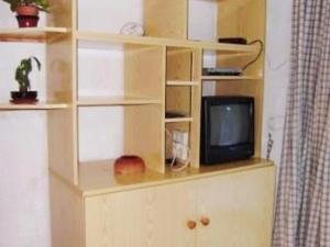 a book shelf with a tv on top of it at Studio cabine 2 pers avec parking à Esquièze-Sère - FR-1-402-124 in Esquièze - Sère