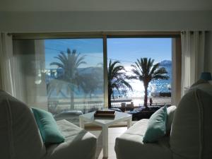 a living room with a couch and a view of the ocean at Le Panoramer Sea View in Cannes