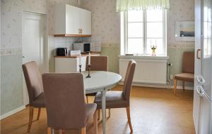a kitchen and dining room with a table and chairs at App, 1 in Edet