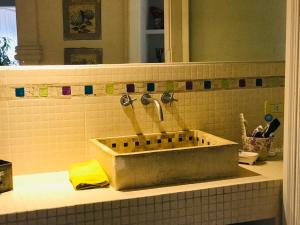 a bathroom sink with two faucets and a mirror at Los trinos in Coronel Suárez