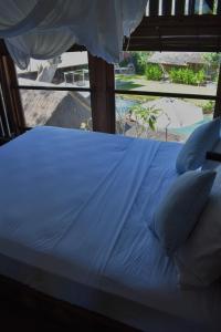 Кровать или кровати в номере Chanteak Bali - Stone House 3