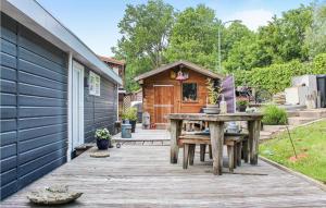 a wooden patio with a table and a house at Amazing Ship In Winsum With Wifi in Winsum