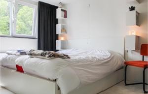 a bedroom with a white bed with a window at Amazing Ship In Winsum With Wifi in Winsum