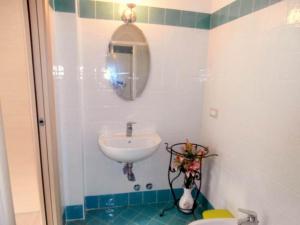 a bathroom with a sink and a toilet and a mirror at B&B della Contrada Varenna in Varenna