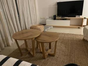 a living room with two tables and a tv at Corrientes Pora in Corrientes