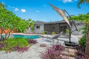 a backyard with a swimming pool and a house at Your private tropical paradise with heated pool! in Sarasota