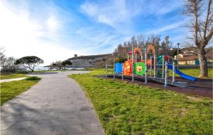 a playground in a park next to a sidewalk at Stunning Home In Scaterina Di Pittinur in Santa Caterina