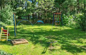 a yard with playground equipment in the grass at 1 Bedroom Nice Home In Harzgerode Ot D in Dankerode +10 photos