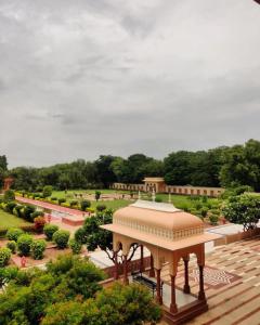 a view of a garden with a gazebo at Umaid Palace - Luxury Resort Near Jaipur Close to Bhangarh & Chand Baori Stepwell Abhaneri in Dubbī