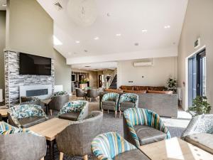 a lobby with tables and chairs and a fireplace at Number 8 Lakes View in Burnham on Sea