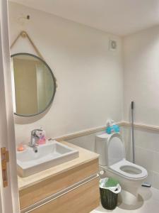 a bathroom with a sink and a toilet and a mirror at Apartment Marassi in El Alamein