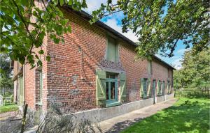 an old red brick building with green windows at Stunning Home In Cormeilles With Kitchen in Cormeilles