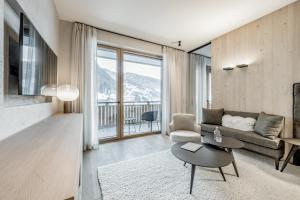 a living room with a couch and a table at Hotel Weisses Lamm in See