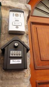 a clock on a stone wall next to a door at Appartamento Da Castlin in Fano