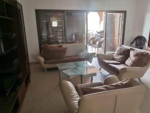 a living room with couches and a coffee table at Talabay AQABA in Aqaba