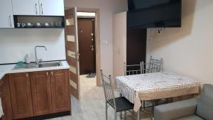 a small kitchen with a table and a sink at Апартамент за гости Ива in Ruse