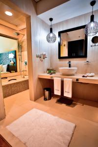 a bathroom with a sink and a bath tub at Signature Hotel Al Barsha in Dubai