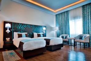 Postel nebo postele na pokoji v ubytování Signature Hotel Al Barsha
