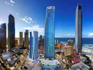 a city skyline with tall buildings and the ocean at LUXURY APARTMENT- with WATER VIEWS FROM EVERY DIRECTION in Gold Coast