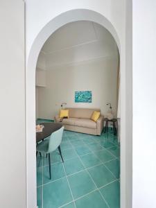 a living room with a couch and a table at Casa Adelaide in Capri