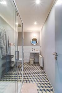 a bathroom with a walk in shower and a toilet at Hotel city.city in Ostrava