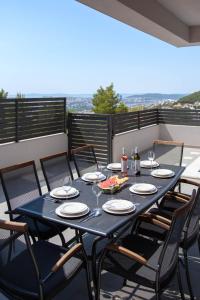 a black table and chairs on a balcony at Villa Dorso with heated pool in Klis