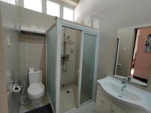 a bathroom with a toilet and a shower and a sink at Hotel Kimberly Tagaytay in Tagaytay