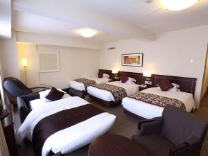 Postel nebo postele na pokoji v ubytování Nishitetsu Grand Hotel