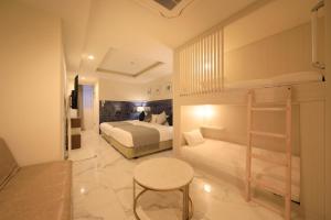 a bedroom with two bunk beds and a table at Centurion Hotel Residential Akasaka Station in Tokyo