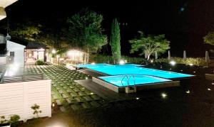 a swimming pool in a yard at night at Antica Stazione in Chiaramonte Gulfi