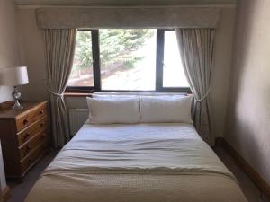 a bed in a small room with a window at 3 bedroom home with stunning views and hot tub in Birmingham