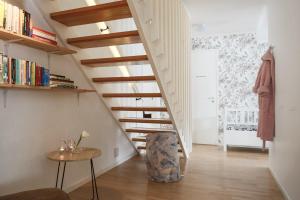 a staircase in a room with a table and a chair at RIBO Apartment Arctic in Kiruna