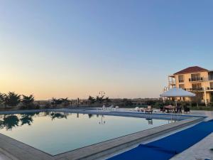 a large swimming pool in a resort at Style Home Buzovna in Baku