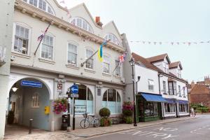 a building on a street with flags on it at Hampden Apartments - The William in Eton