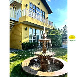 a water fountain in front of a house at Kamal Resorts - The Luxury Of Being Yourself in Ludhiana