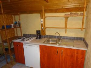 a kitchen with a sink and a stove at maisonnette écologique isolée en botte de paille in Ploërmel