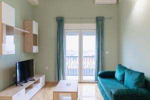 AirMi hotel في Surčin: غرفة معيشة مع أريكة زرقاء وشرفة