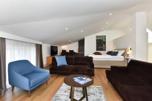 a living room with a couch and a bed at Novem in Zadar