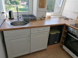 a kitchen with a sink and a counter top at Ferienwohnung Civrilli 3 in Dippelsdorf