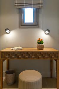 a table with two lights and a plant on it at Coocono Villas in Tinos