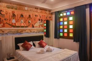 a bedroom with a bed and a stained glass window at Hotel Lake Bridge in Udaipur