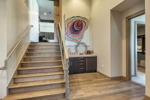a staircase leading to a kitchen with a painting on the wall at Four Bedroom Penthouse apartment hotel in Park City