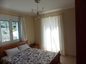 a bedroom with a bed and a window at Theofilos house in Nafplio