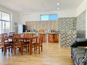 a kitchen and dining room with a table and chairs at villa liam kiwengwa zanzibar in Kiwengwa
