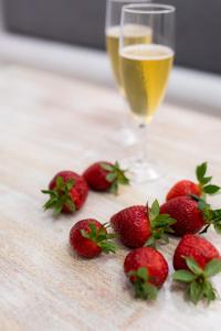 a group of strawberries and a glass of champagne at Arco Naxos Luxury Apartments in Naxos Chora