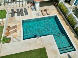 an overhead view of a swimming pool in a backyard at Linc Rooms & Apartments in Banjole