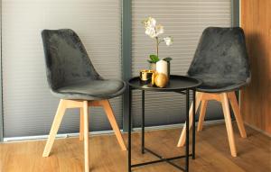 two chairs and a table with a vase on it at 1 Bedroom Awesome Ship In Brandenburg in Brandenburg West