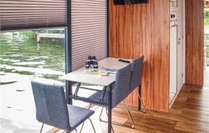 a table and chairs in a room with water at 1 Bedroom Awesome Ship In Brandenburg in Brandenburg West