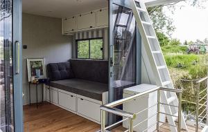 a tiny house with a couch and a ladder at 1 Bedroom Awesome Ship In Brandenburg in Brandenburg West