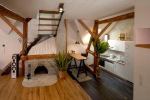 a loft bedroom with a bed and a fireplace at Studio Loft Murau - im Herzen der Altstadt in Murau